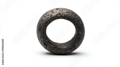 Abstract shaped concrete ring in focus with textured surface and soft shadow
