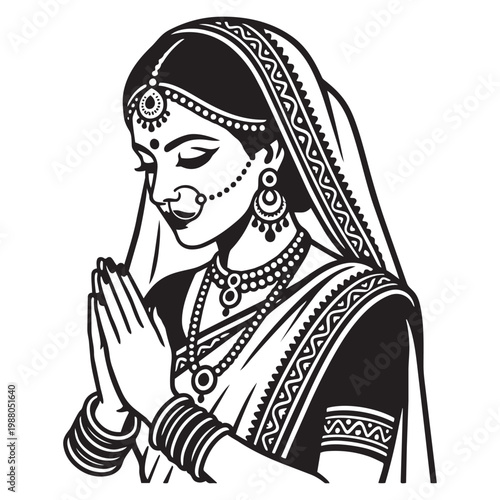 Indian woman in traditional clothing praying.