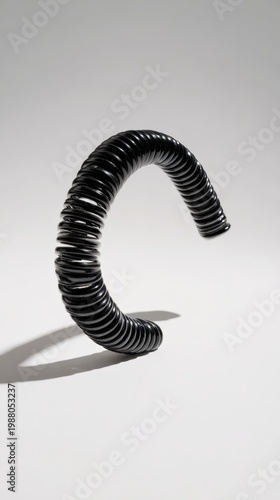 Abstract black spiral sculpture on light background with smooth curvature