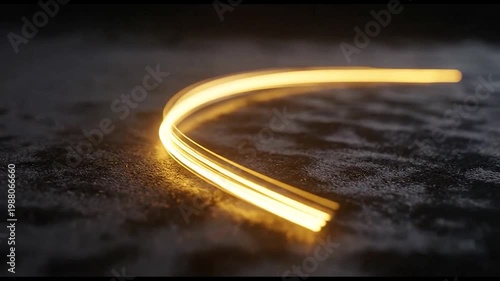 Glowing light trail on dark surface.