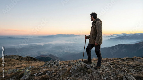 Serene Mountain View: A Man Enjoys The High Ground At Sunrise, Embracing Nature's Beauty In A Peaceful Landscape During The Golden Hour