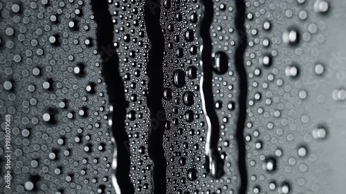 Macro shot of water droplets on dark textured surface
