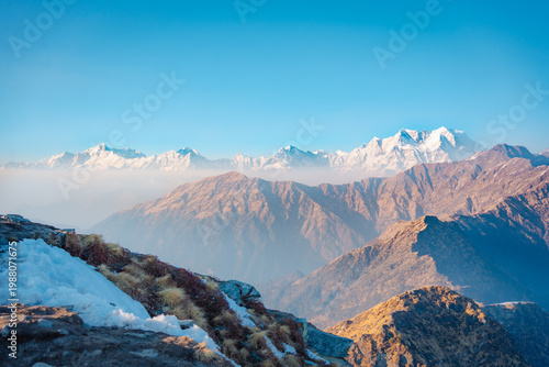 Photography Snow-capped mountains under a clear blue sky near Tungnath temple, Uttarakhand,