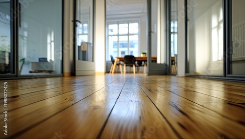 Low angle view of polished wooden floor leading into a bright, modern office interior