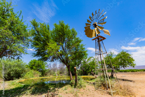 Windmill wind pump borehole in arid landscape