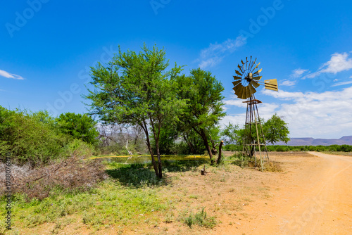 Windmill wind pump borehole in arid landscape