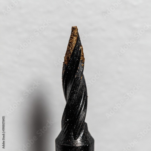 Close up view of a twisted drill bit on a plain background