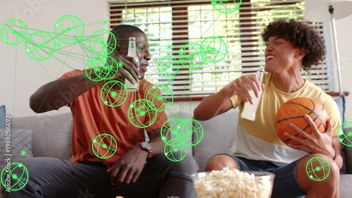 Off-frame play sparking pals sitting couch lifting drinks clinking drinking ball popcorn green dots