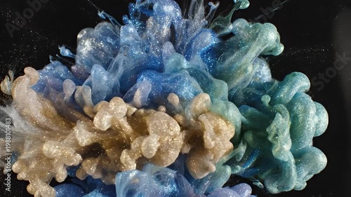 Dynamic blue turquoise ink cloud spreading on black