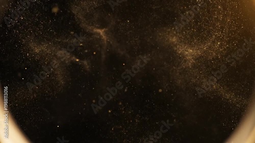 Golden ring with sparkles on black.