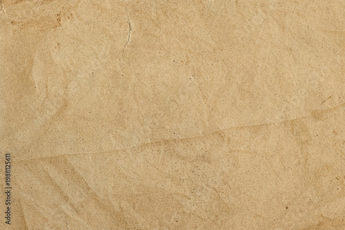 texture of aged, crumpled beige paper. kraft paper or parchment.