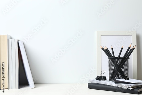 Modern workspace with stationery and textbooks on white table