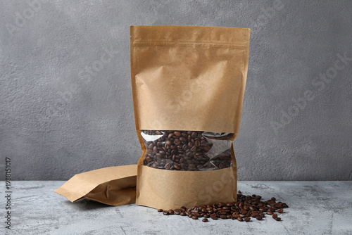 Bags of coffee beans on gre...