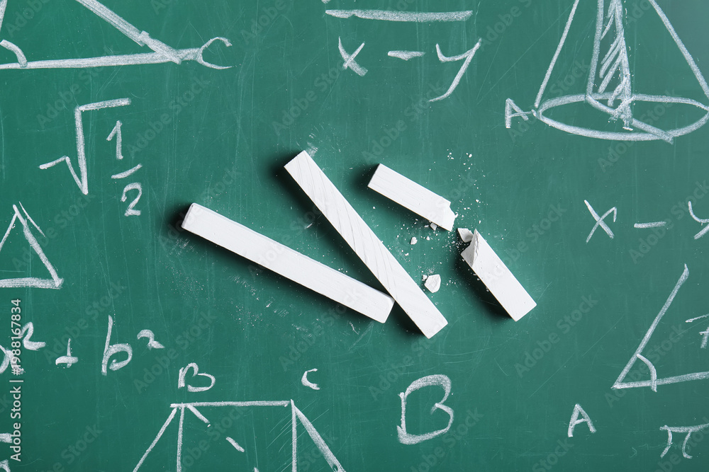 Fototapeta premium Different drawn geometric figures and math formulas with white chalks on green chalkboard