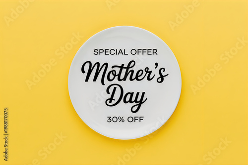 Round white ceramic plate with mothers day special offer text on a yellow background