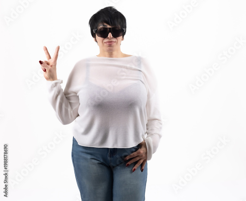 Modern young woman showing peace sign and wearing glasses