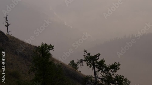 Southern Urals, Southern Kraka mountain range in summer: mountains in the dawn haze.