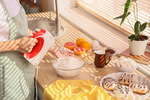Woman whipping egg whites w...
