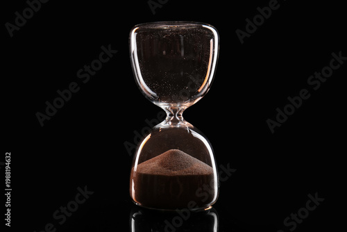 Crystal hourglass on dark b...