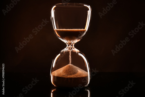 Crystal hourglass on dark b...