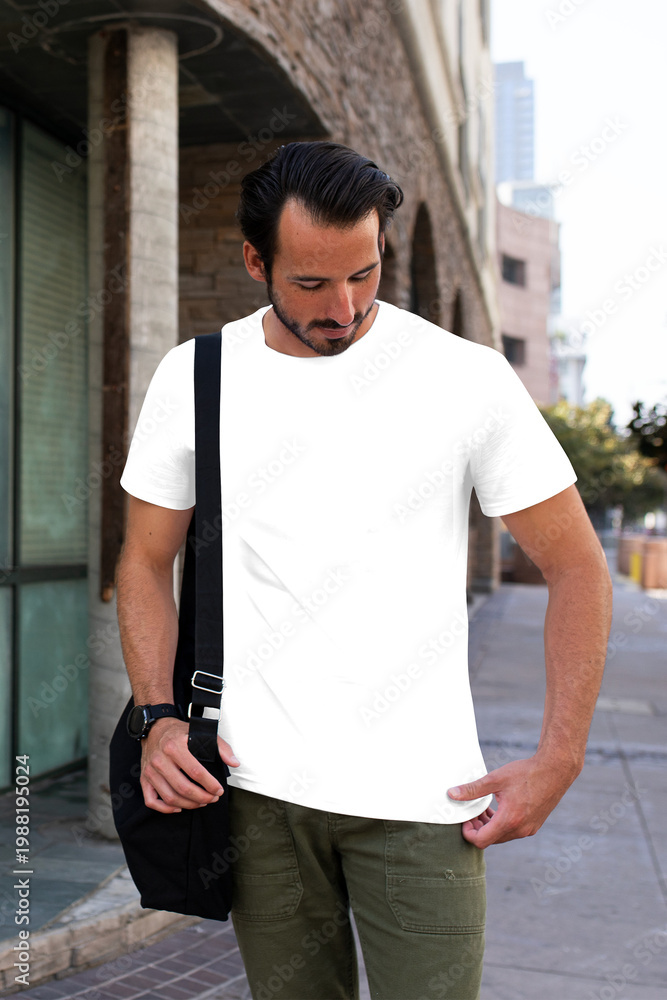Fototapeta premium Png men's tee apparel mockup on a man with laptop bag street style fashion