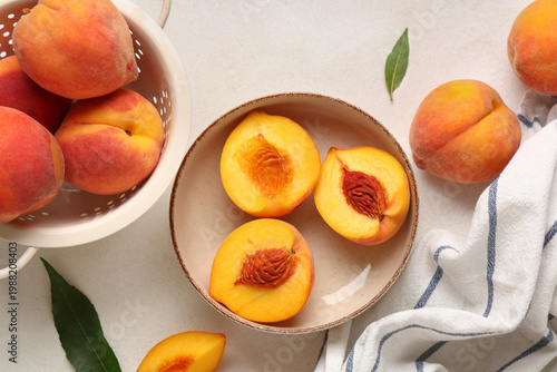 Bowl and colander with sweet ripe peaches on white background