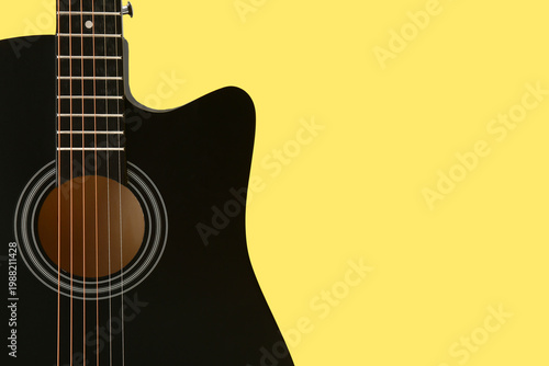 Modern black guitar on yell...