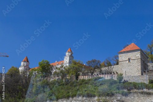Photography Bratislava Castle medieval fortress on the hill under a clear blue sky