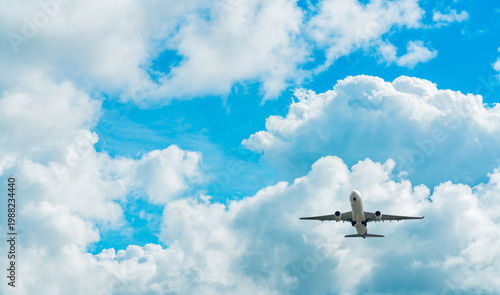 Fényképezés Under view of commercial passenger airplane flying in blue sky, aviation travel