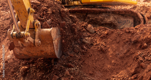 Εκτύπωση καμβά Backhoe working by digging soil at construction site