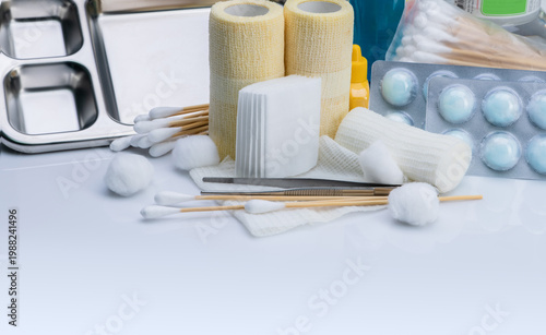 Wound care dressing set. Medical supply for diabetes, surgical and accidental wounds care. Medical equipment for nurse. Forceps, cotton stick, conform bandage, and elastic cohesive retention bandage.