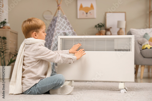 Cute little boy warming han...