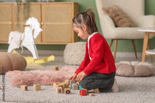 Cute little girl playing wi...