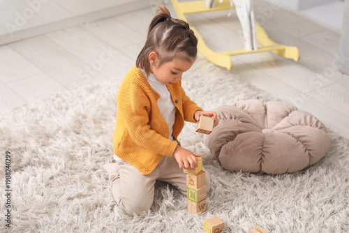 Cute little girl playing wi...