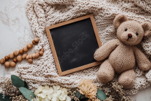 Teddy Bear with Chalkboard on Knitted Blanket.