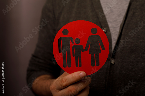 Person holding a red family...