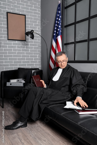 Mature judge with law book ...