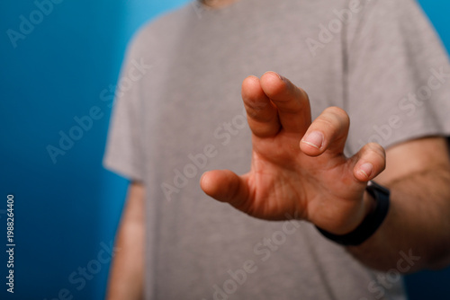Close-up of a hand reaching...