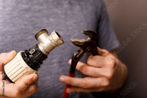 A close-up of a plumber's h...