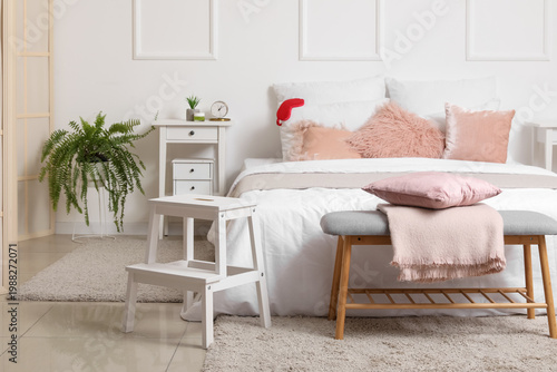 Interior of light bedroom w...