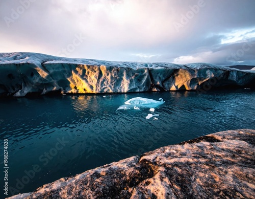 majestic arctic landscape with massive glacier wall and dark cold water, golden sunset reflection on icebergs, climate change and environment, polar exploration