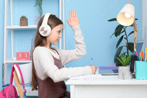 Little girl in headphones s...