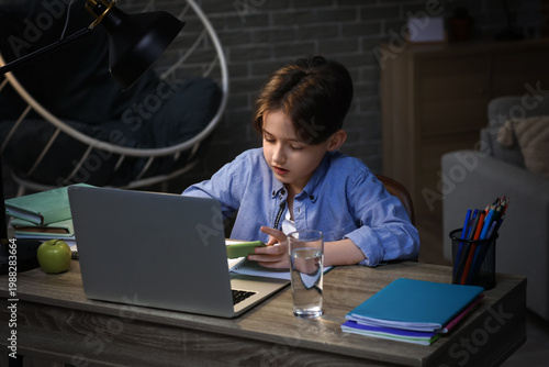 Little boy doing homework w...