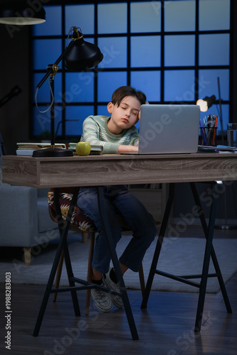 Sleepy little boy with doin...