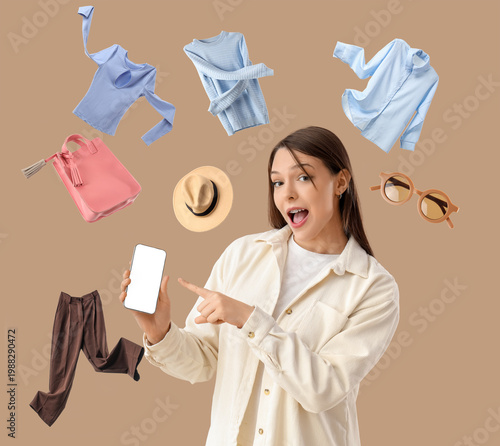 Shocked young woman pointing at mobile phone on brown background