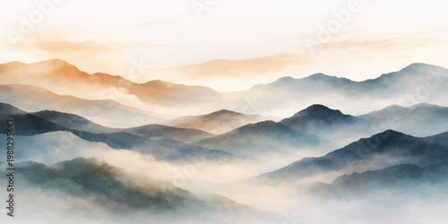 A misty morning sun rises over blue mountain peaks shrouded in dark fog and clouds across a vast nature landscape view