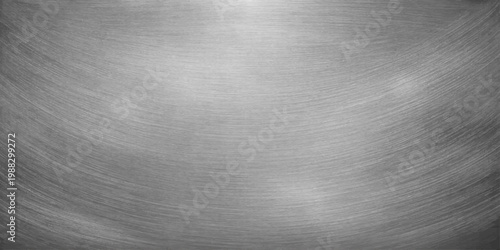 A polished silver stainless steel plate with a brushed metallic texture provides a shiny industrial grey surface pattern for a sleek aluminum material backdrop