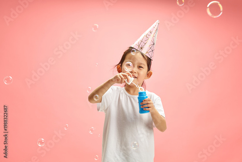Canvas Print Cheerful Female Kid Around 5-6 Years Old Happy Blowing Soap Bubbles Wearing in P
