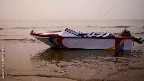 A morning coastal video footage taken at Digha Beach, India, featuring a single-hull fibreglass boat swaying in the gentle waves beneath a soft, hazy sky. Ideal themes for travel, tourism, and nature.