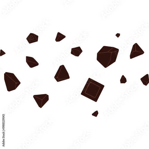 Chocolate chunks are falling from above onto a white surface.